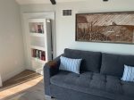 Secret room behind the bookcase with couch and TV